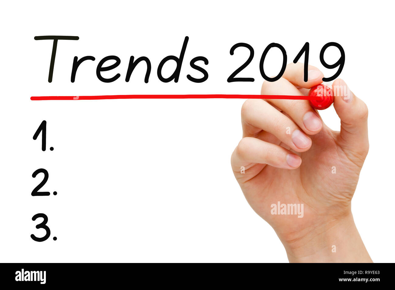 Hand writing blank Trends for year 2019 list with marker on transparent wipe board isolated on white. Stock Photo