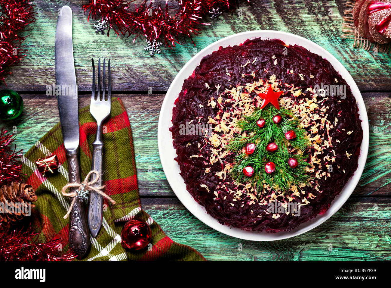 Vegetable salad from beetroot with Christmas tree decoration on the green table at New Year time Stock Photo