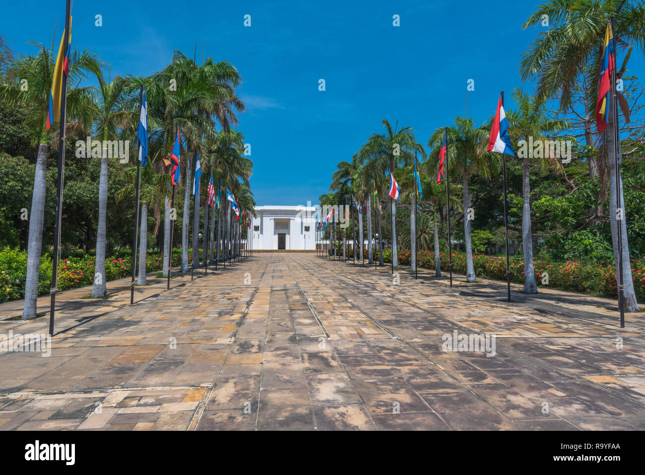 Santa Marta, Columbia -- April 22, 2018. A flag lined path leads up to a museum dedicated to Simon Bolivar. Stock Photo