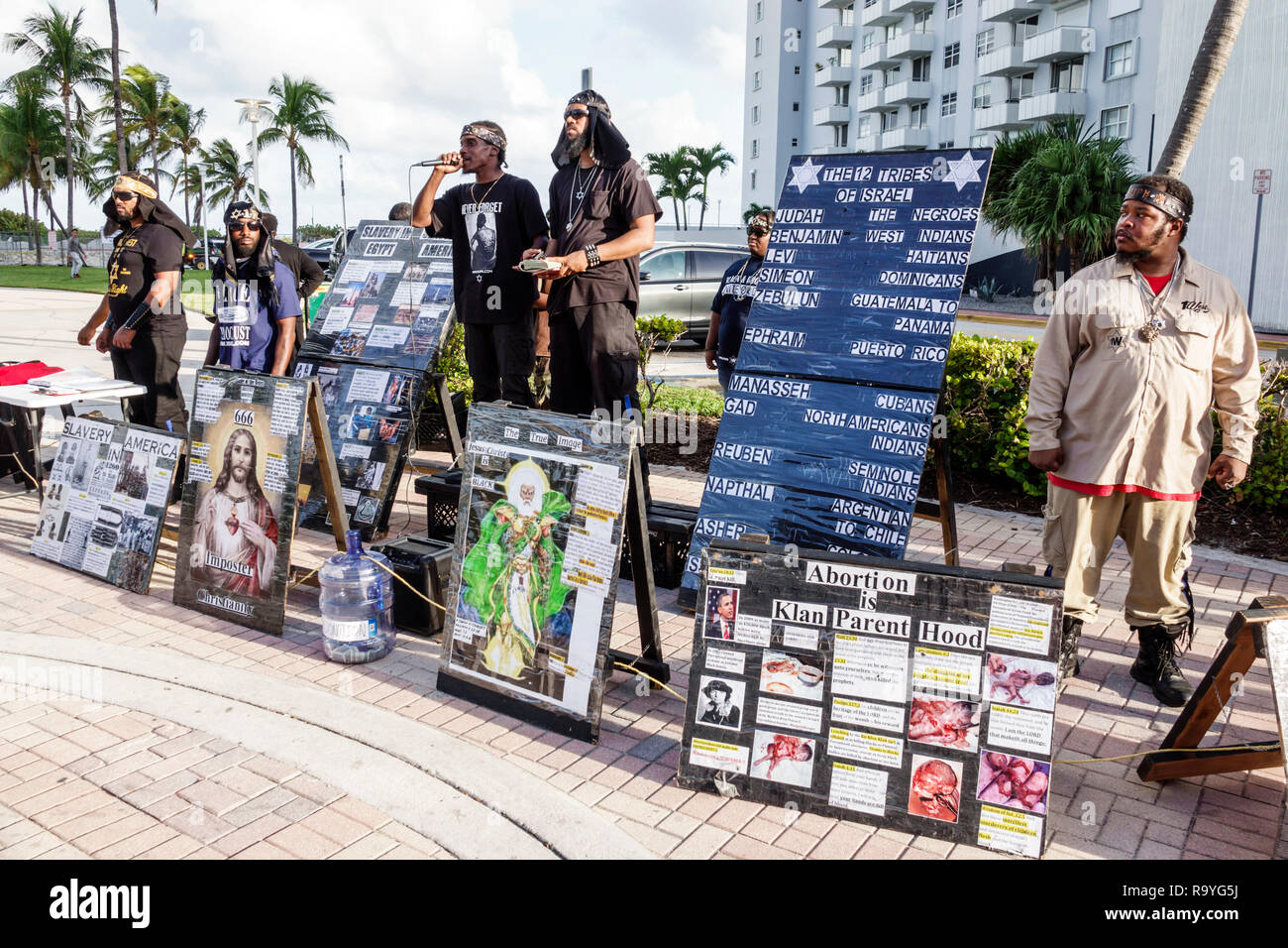 Miami Beach Florida,Lummus Park,free speech speaking speaker,ISPUK,Israelite School of Universal Practical Knowledge,Black man men male,signs,FL181222 Stock Photo