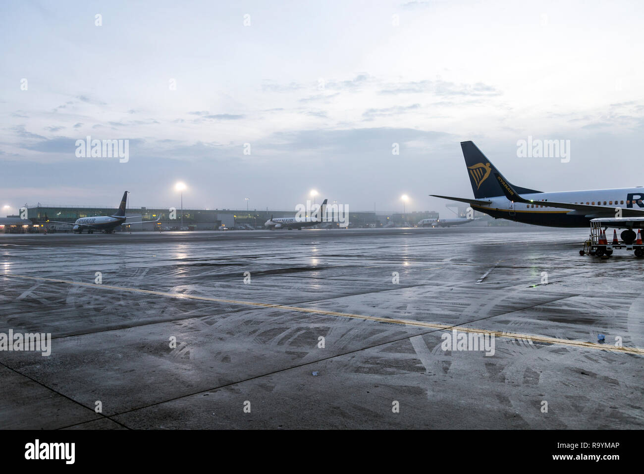 Ryanair airplanes taxiing on the tarmac of Stansted airport in foggy weather conditions, London, UK Stock Photo