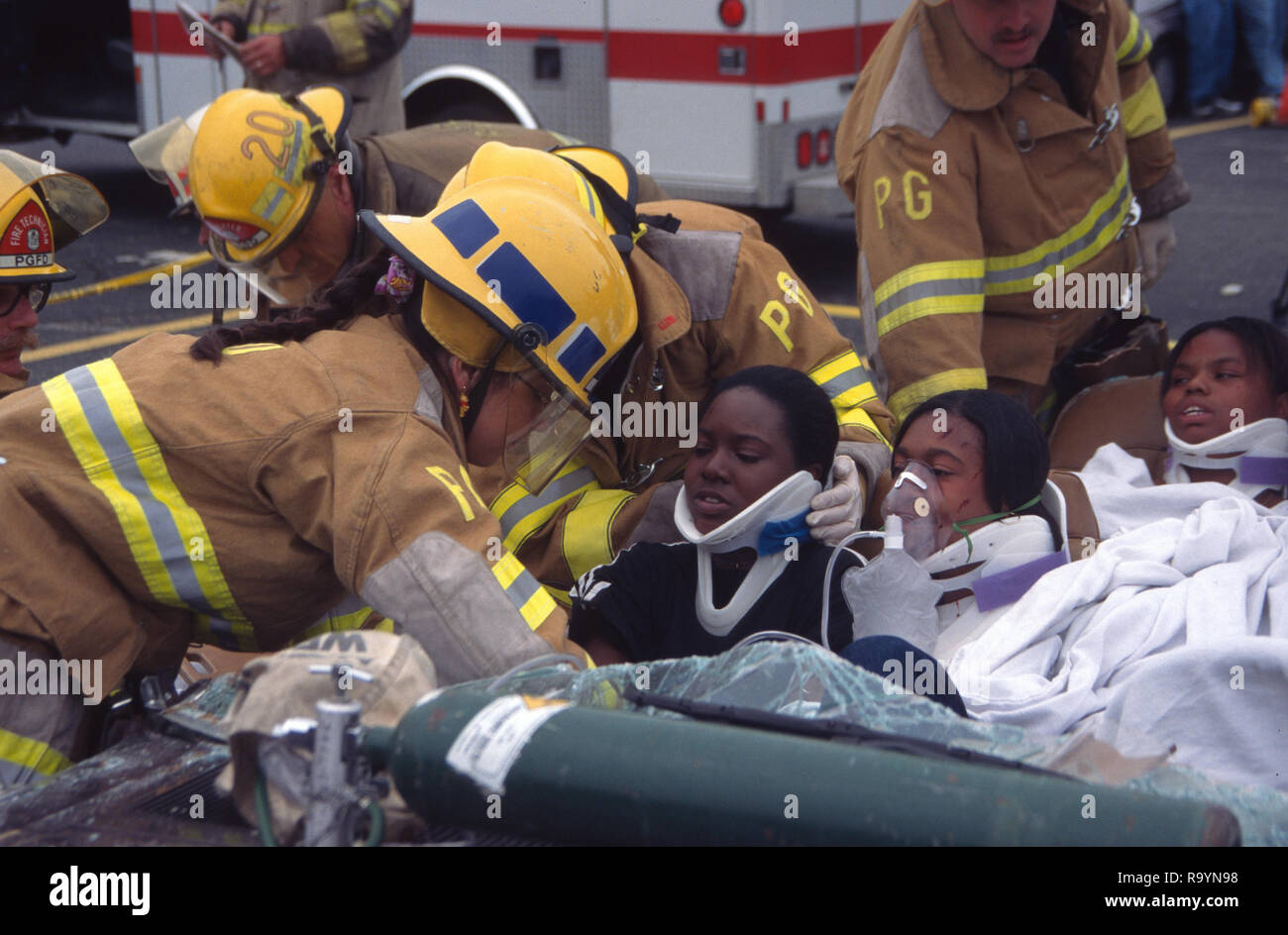 Firefighters work on rescuing injured people injured in an auto accident Stock Photo