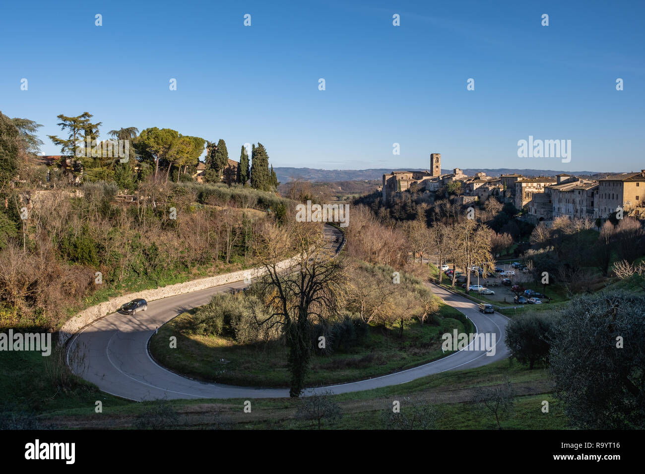 Panoramic view and  provincial road with the medieval towers of the village of Colle di Val d'Elsa, Siena, Tuscany Stock Photo