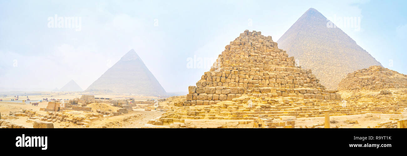 Panoramic view on Giza pyramids through heavy winter morning fog and sandy clouds, Egypt Stock Photo