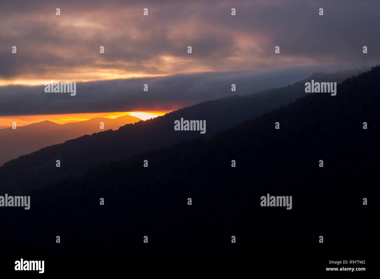 Nice sunset between mountains and wild forests Stock Photo - Alamy