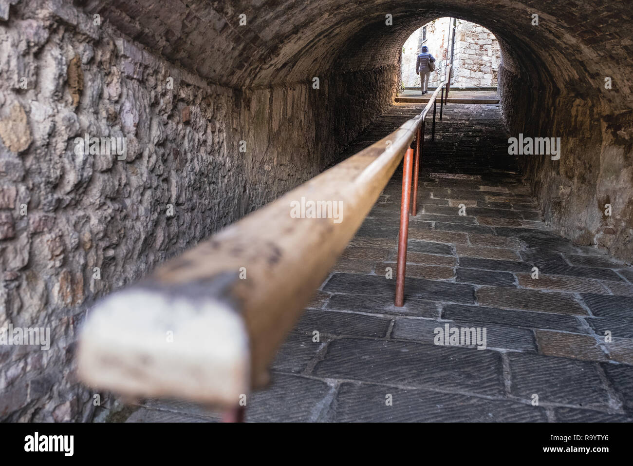 Road behind the walls with the pedestrian access gallery to the medieval village of Colle di Val d'Elsa, Siena, Tuscany Stock Photo