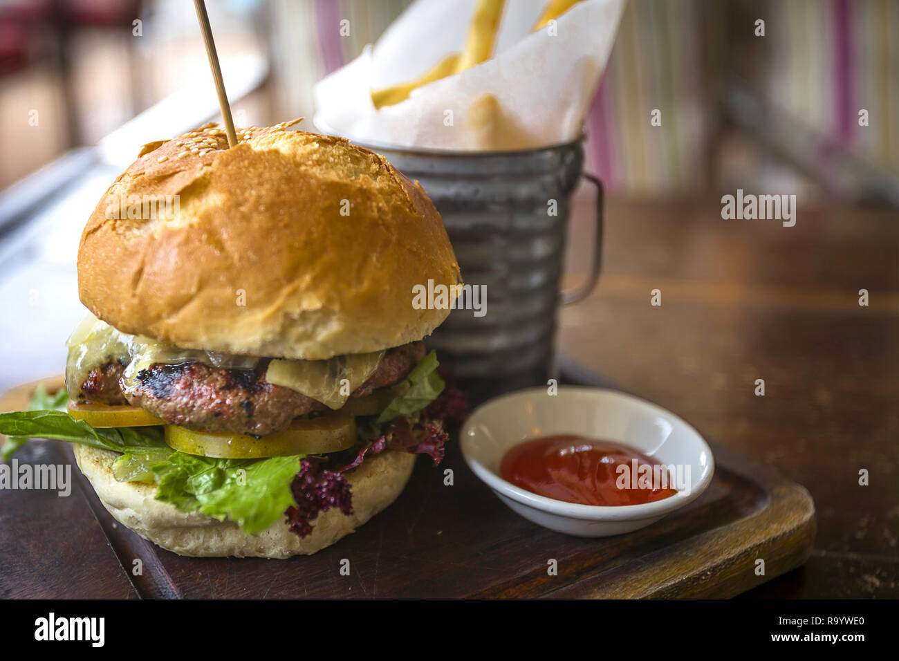 Gourmet Burger with a side of Ketchep and fries in a basket. Served at  western style restaurant in Asia Stock Photo - Alamy