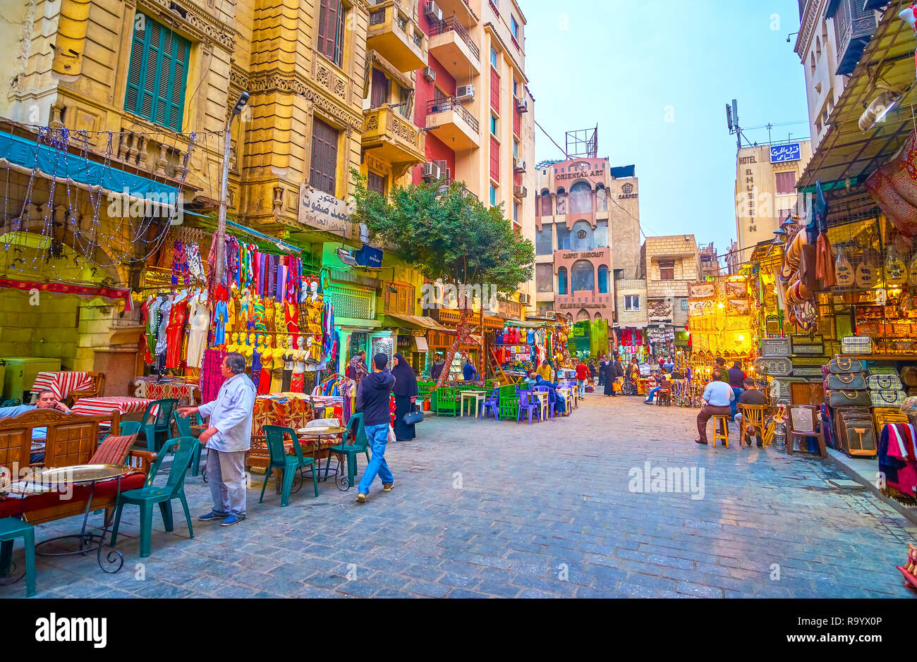 CAIRO, EGYPT - DECEMBER 20, 2017: The wide street with traditional Egyptian restaurants in Khan EL-Khalili Souq that alternate with souvenir and cloth Stock Photo