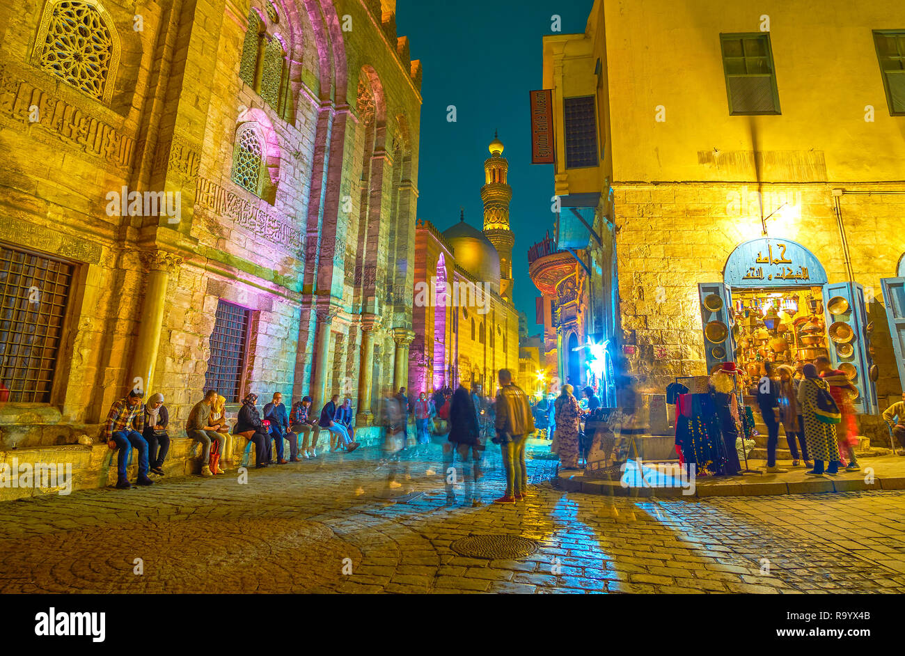 CAIRO, EGYPT - DECEMBER 20, 2017: The beautiful illuminated historical edifices in Al-muizz street  attract people to spend a time here and enjoy magn Stock Photo