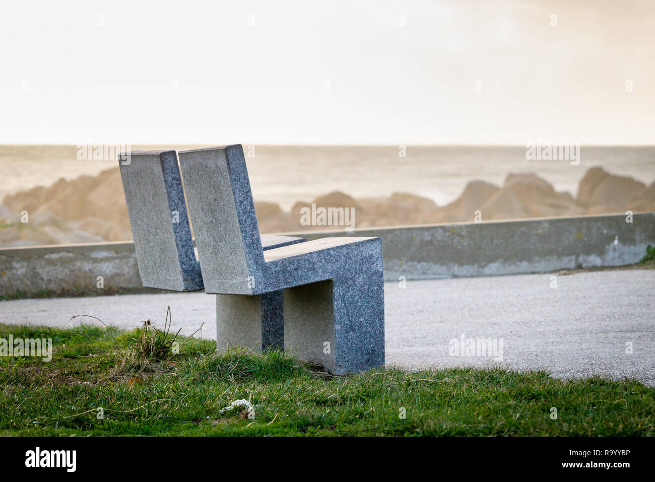 Two marble stone benches face the distant seascape. Copyspace Stock Photo