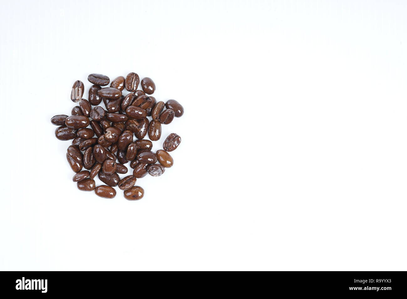 Roasted coffee beans close-up with white background Stock Photo - Alamy