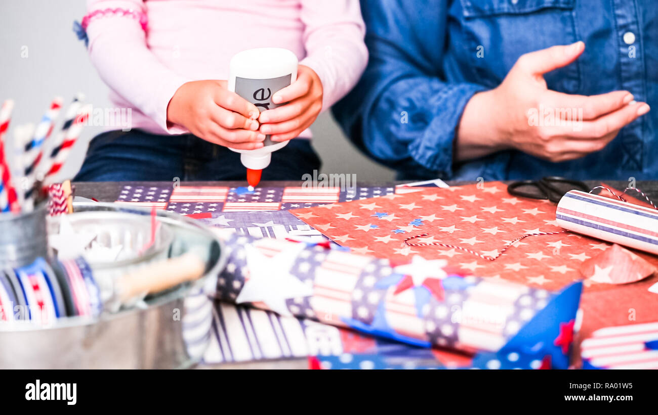 Step by step. Mother and daughter making paper firecrackers for July ...