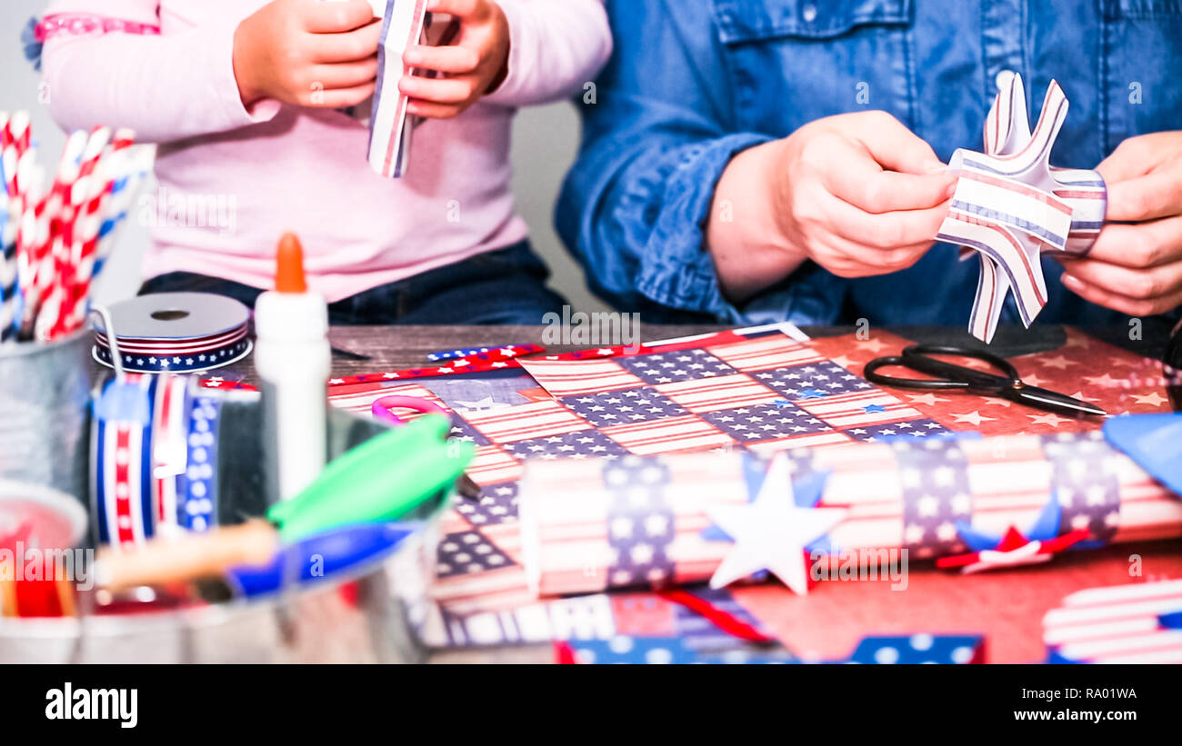 Step by step. Mother and daughter making paper firecrackers for July ...