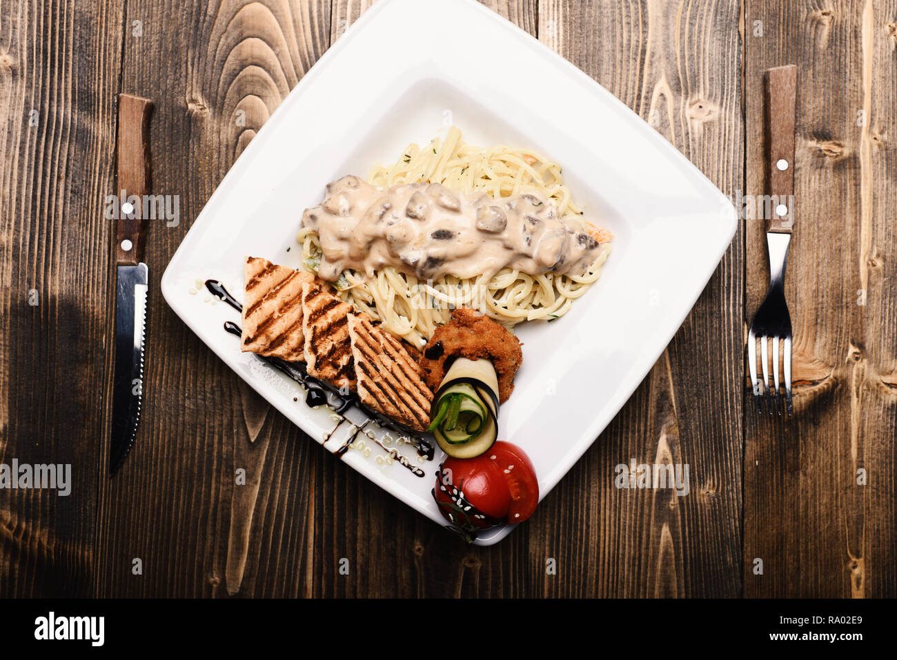 Main course concept. Italian spaghetti with chicken and mushrooms ...