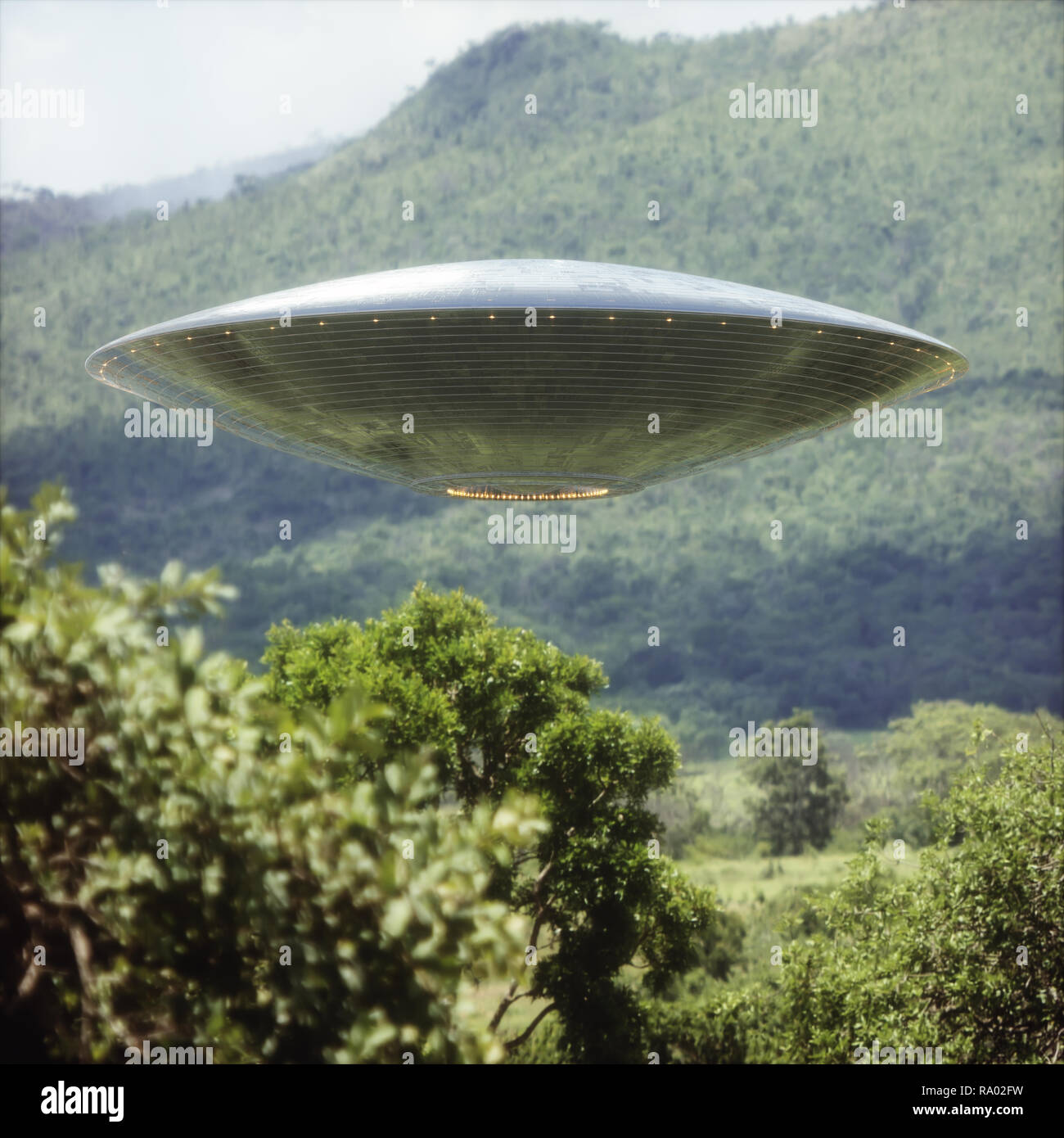 Unidentified flying object over a forest with trees and mountains behind. Stock Photo