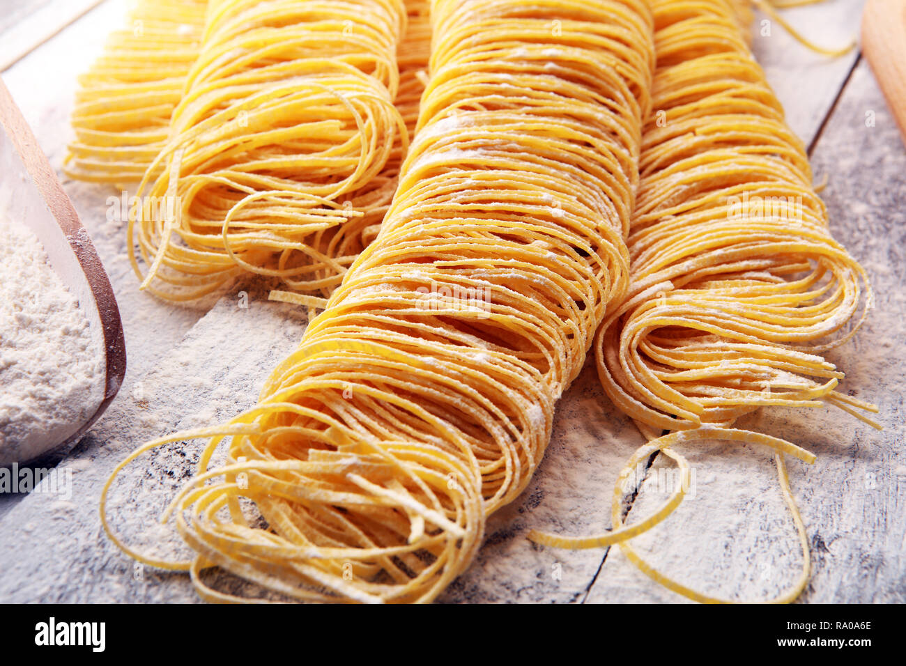 View of pasta. Fresh homemade pasta with pasta ingredients on the rustic table ...