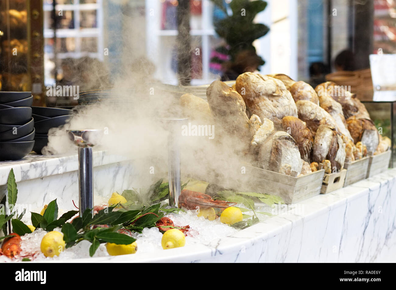 dry ice and steam with fresh fish and bread on an market stall Stock Photo