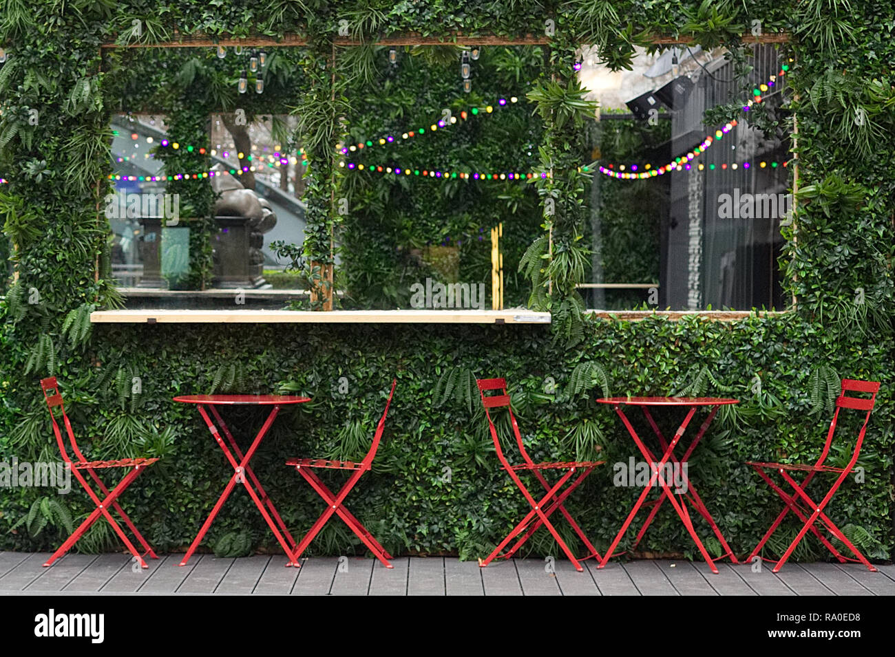 living plant wall and red dinning tables and chairs Stock Photo