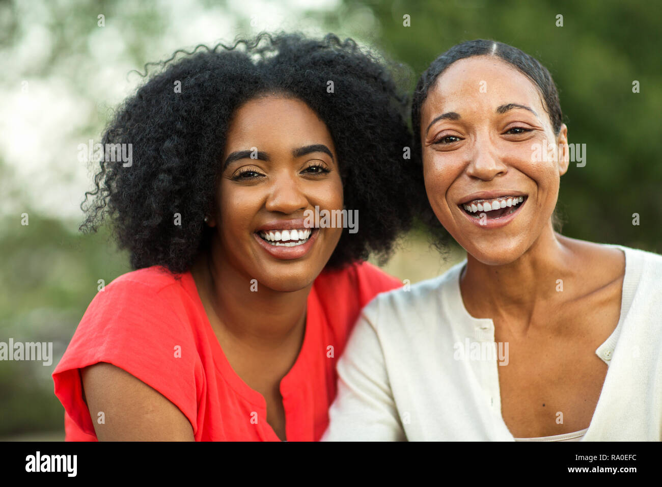 African American mother hugging her adult daughter. Stock Photo