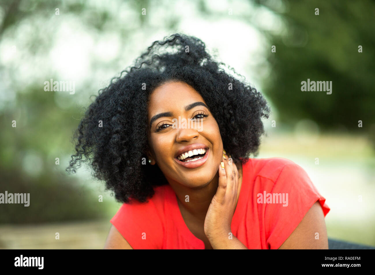 Happy confident African American woman smiling outside Stock Photo - Alamy