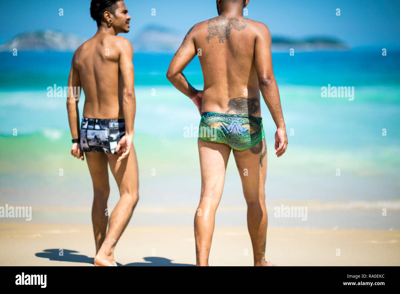 RIO DE JANEIRO - FEBRUARY, 2018: A pair of young men on Ipanema Beach walk  to the sea in sunga, a style of swimwear popular in Brazil Stock Photo -  Alamy