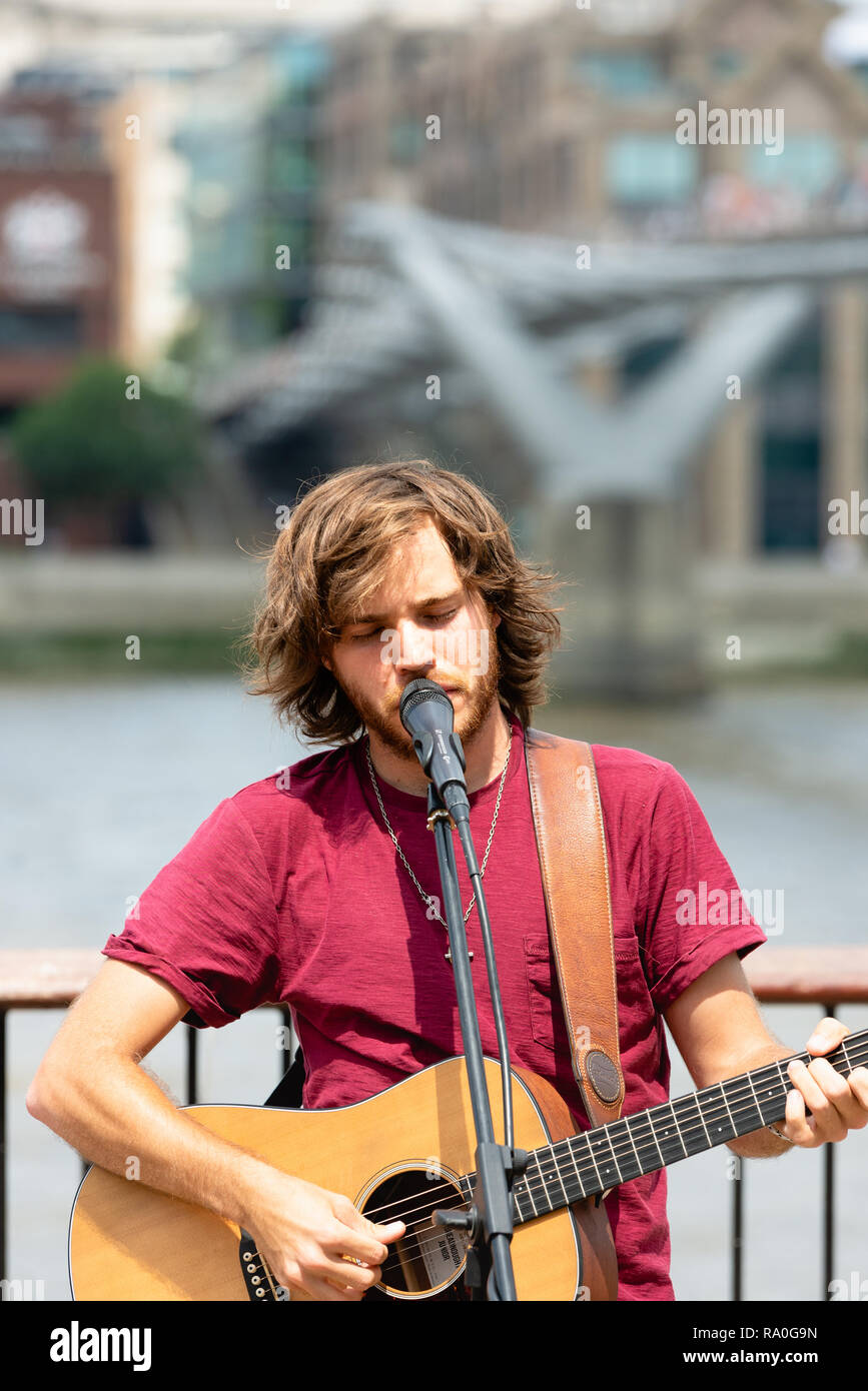 Busker playing guitar at Southbank, London Stock Photo - Alamy