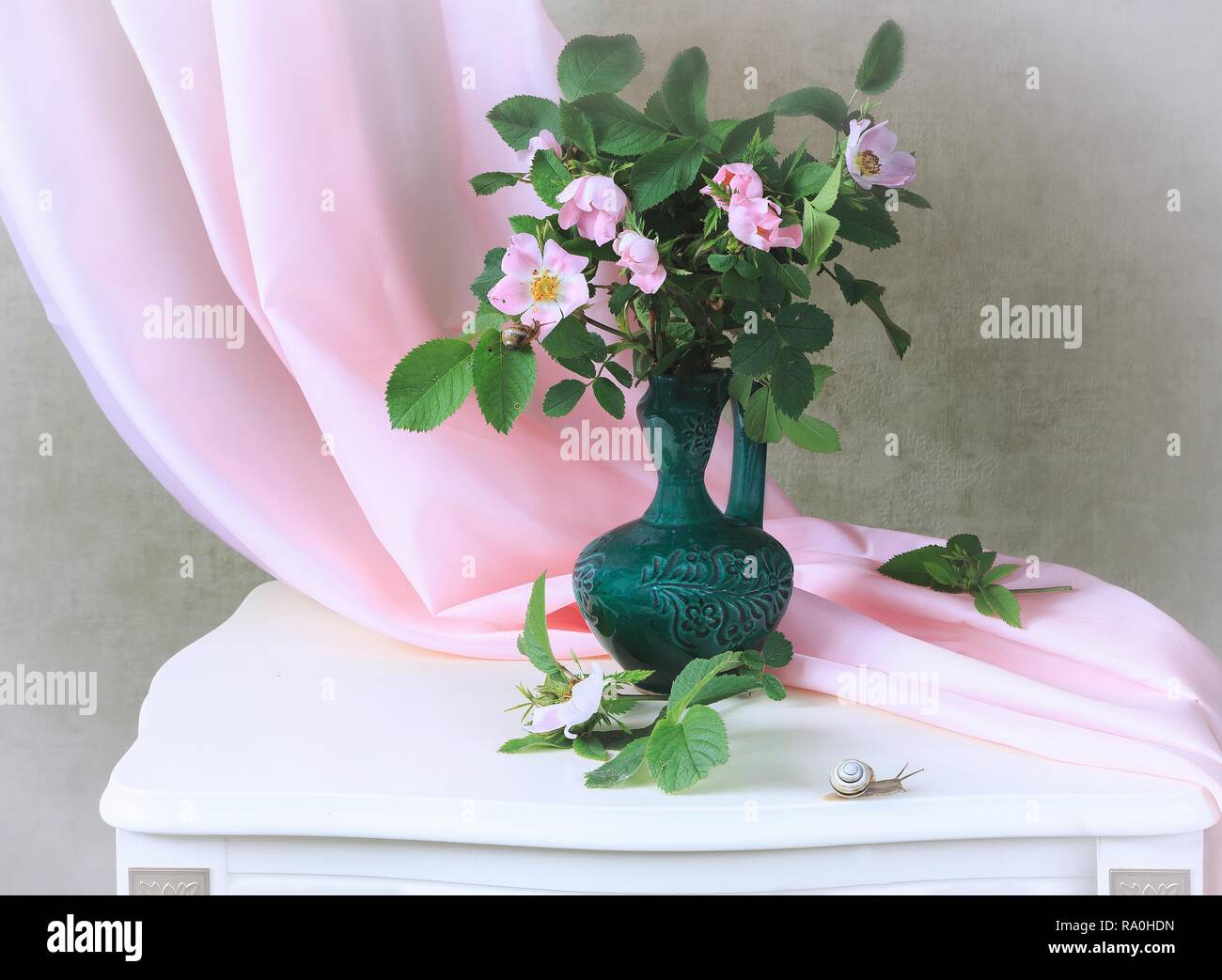 Still life with bouquet of pink wild roses Stock Photo - Alamy