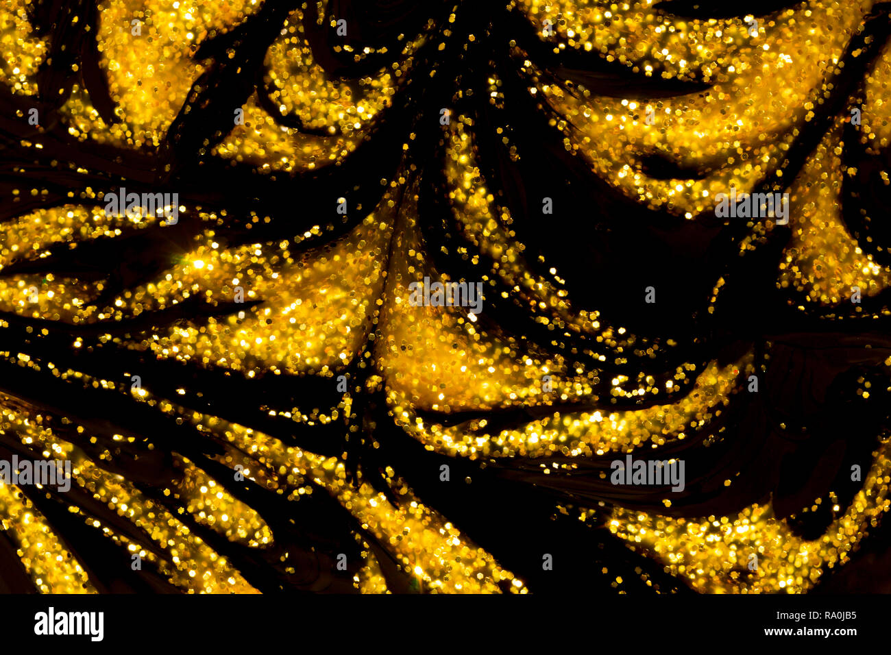 Abstract background illustration of liquid gold glitter paint swirls on  black background Stock Photo - Alamy