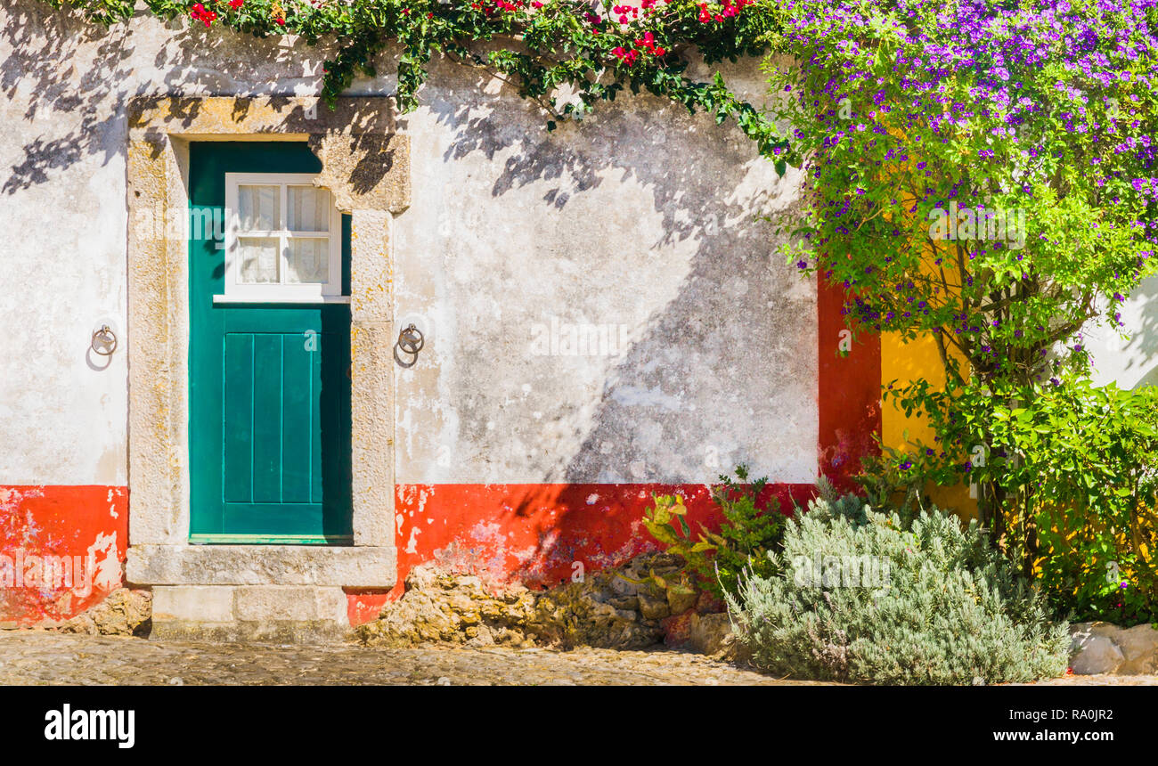 traditional house with stone framed door and flowers Stock Photo - Alamy