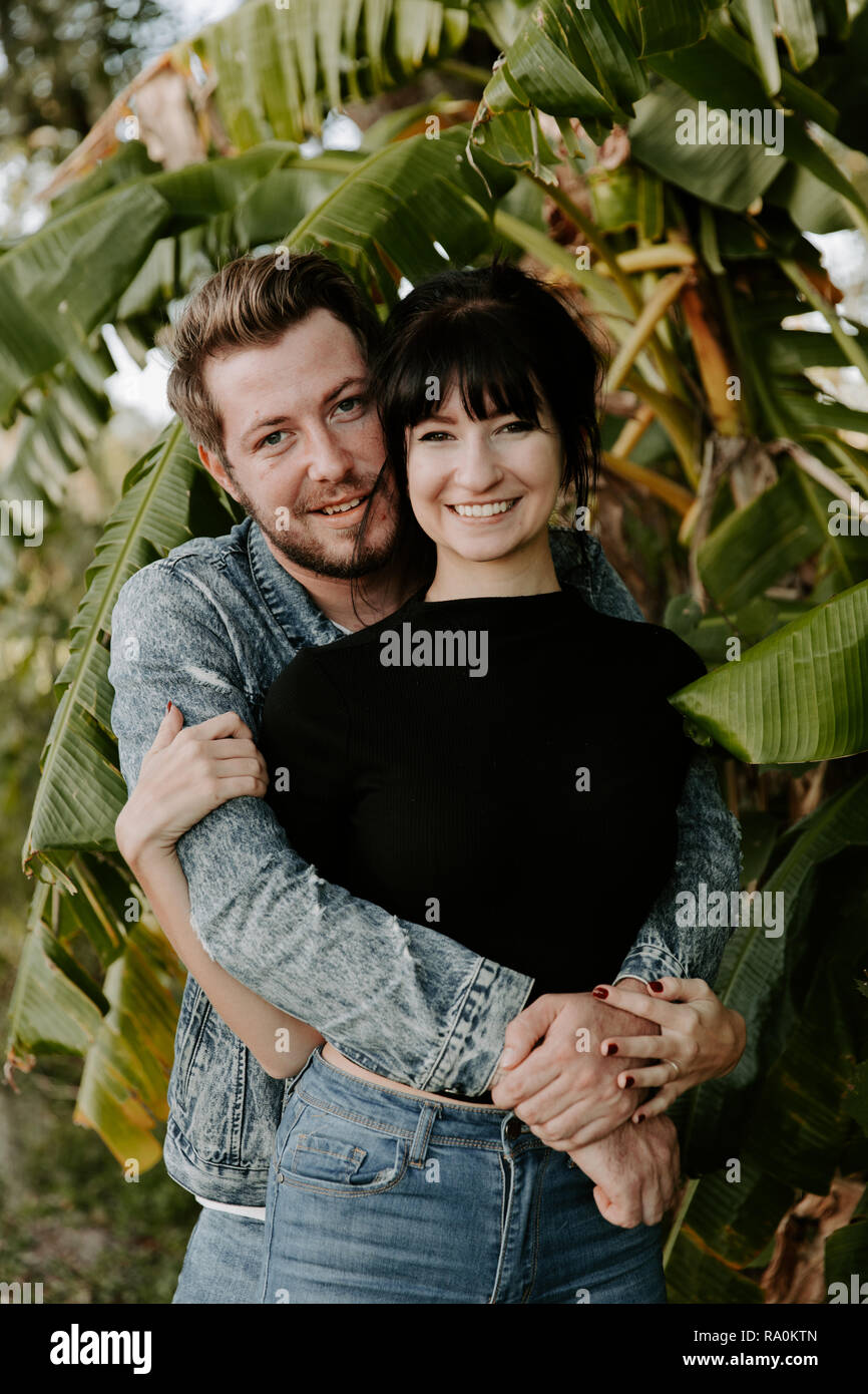 Portrait of Two Cute Modern Caucasian Beautiful Young Adult Guy Boyfriend  Lady Girlfriend Couple Hugging and Kissing in Love, Nature with Green  Plants Stock Photo - Alamy, image size:866x1390