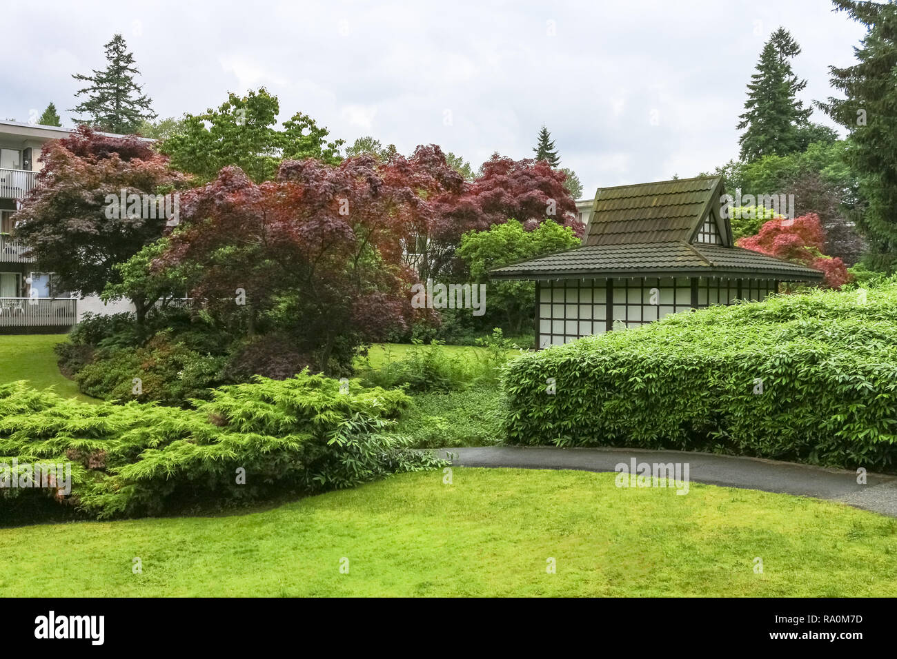 Paved pathway over small park in residential area Stock Photo - Alamy