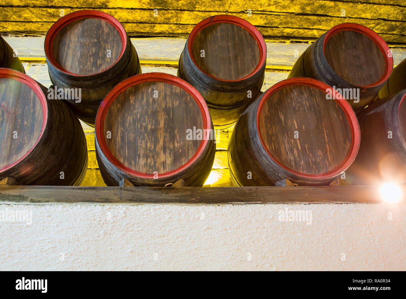 Underground wine barrels stack, winery cellar storage area with wooden