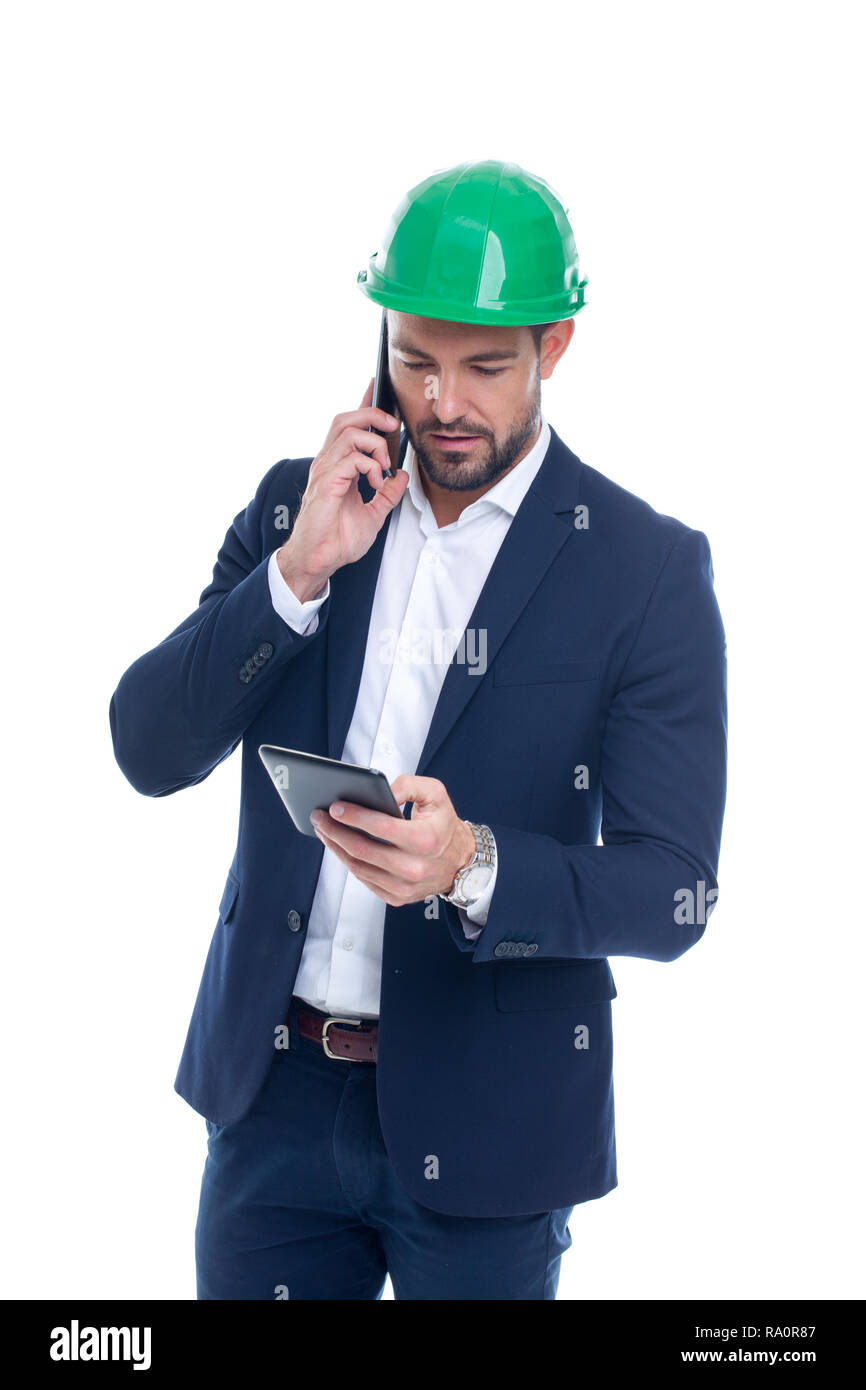 Construction manager calling and using tablet isolated on white background Stock Photo
