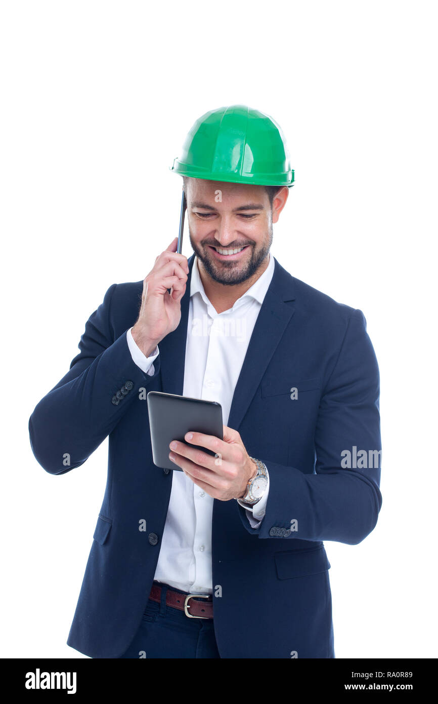 Happy young construction manager calling and using tablet isolated on white background Stock Photo