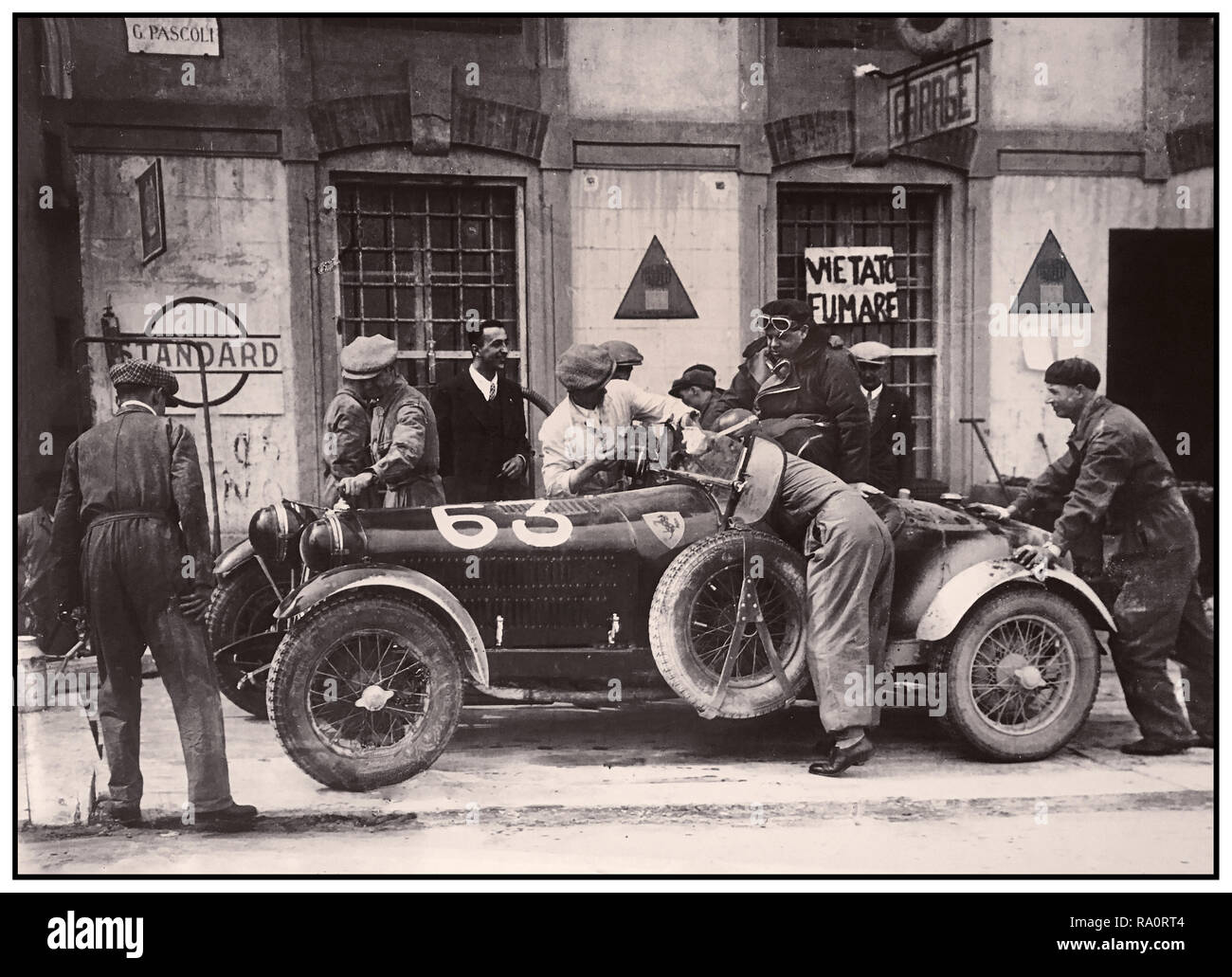 Vintage 1932 Mille Miglia Italian road race, a brief pit stop for Number 63 Alfa Romeo 6C 1500 SStf Spider Zagato entered by Scuderia Ferrari and finished the endurance race in 6th place. The Mille Miglia (1000 Miglia) was an open-road, motorsport endurance race which took place in Italy twenty-four times from 1927 to 1957. Stock Photo