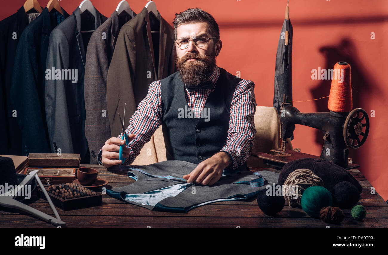 Confident tailor. retro and modern tailoring sewing