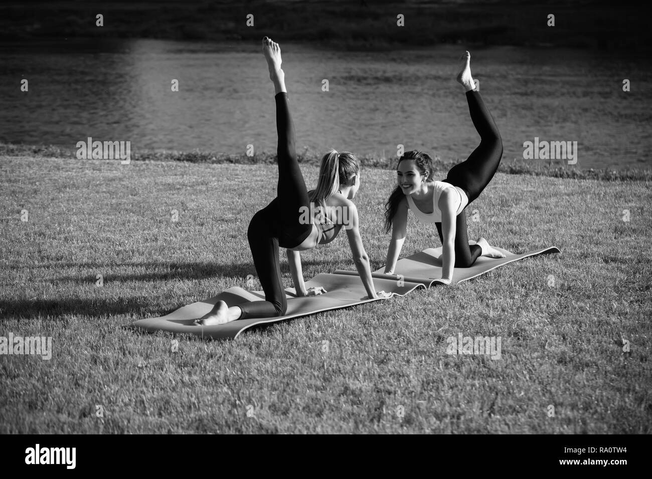 Women At Sport Workout On Fitness Mat Sunny Outdoor On Green Grass