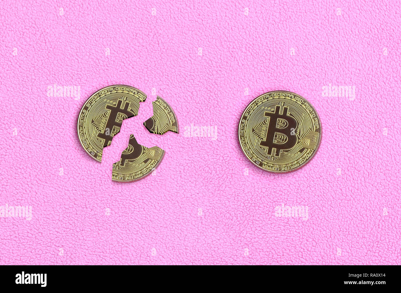 Broken into pieces bitcoin lying on a pink fleece fabric background. The  fall and collapse of the course of crypto currency. Bad news for  cryptocurren Stock Photo - Alamy