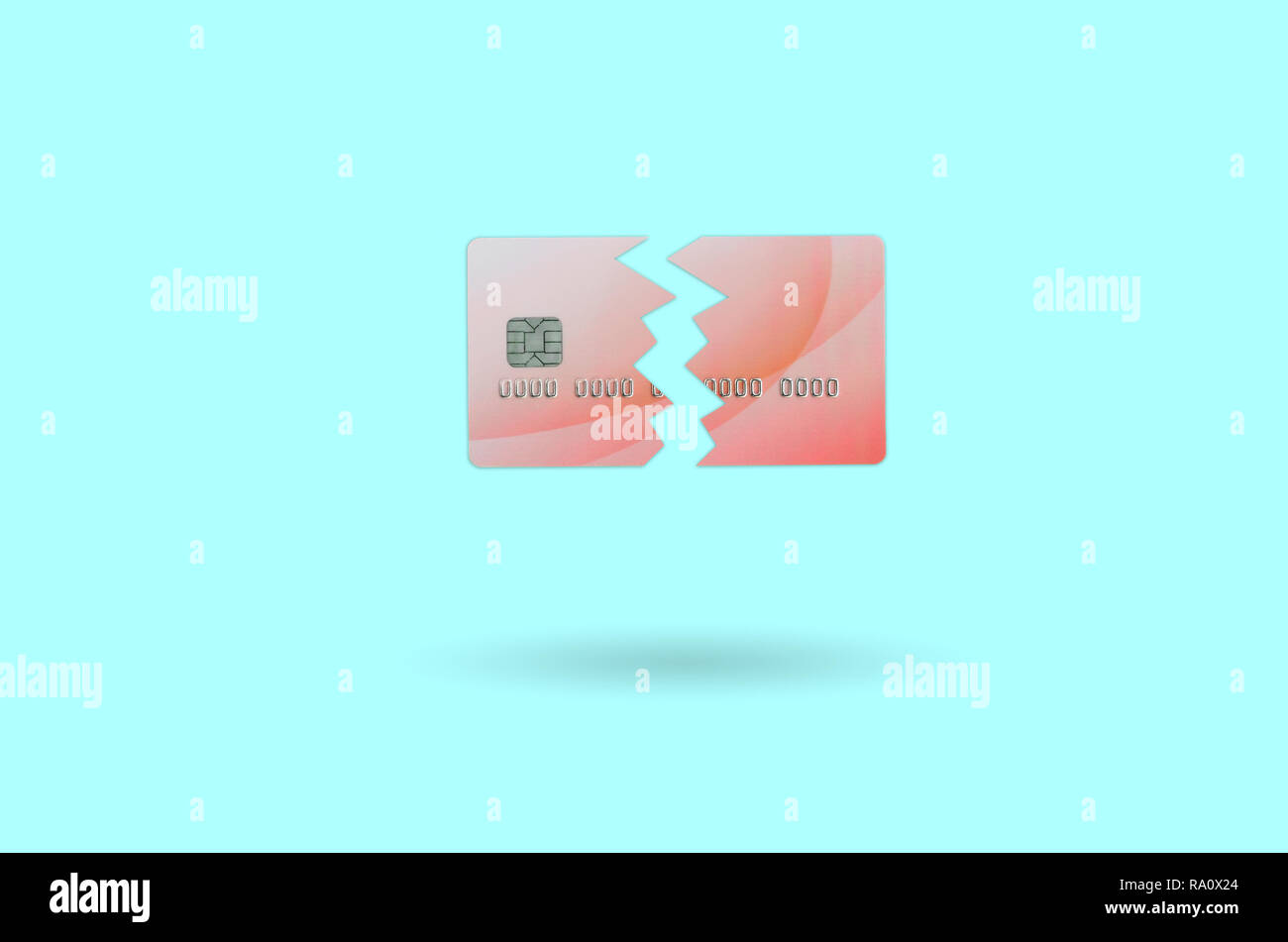 Cut and broken red credit card floating in the pastel blue space. The concept of ban to use banking services. Credit card expire end soon Stock Photo