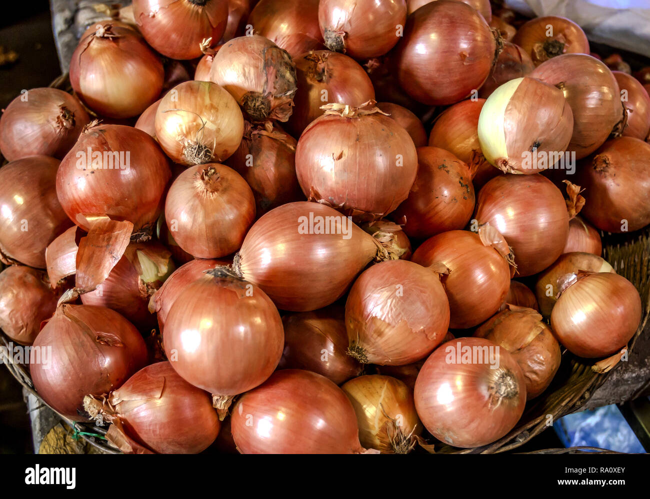 A stack of onions in a basket at an Asian Market. Market onions Stock