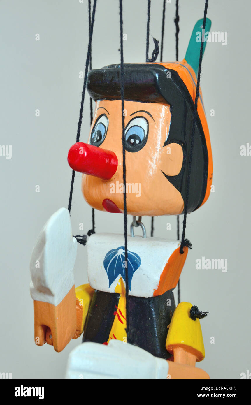 Wooden puppet of Pinocchio, the fictional character of the children's novel The Adventures of Pinocchio (1883) by Italian writer Carlo Collodi. Stock Photo