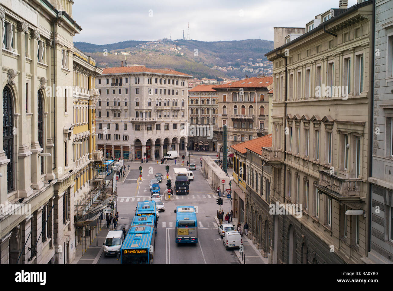 TRIESTE, ITALY - JANUARY 14, 2015: Traffic and public transport between the historic buildings on the Piazza Goldoni in Trieste, Italy, Stock Photo
