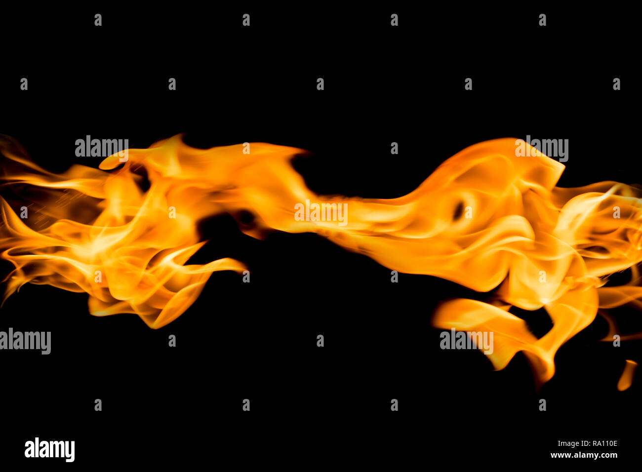 Fire flames on black background. Bright and colorful fire against a black night. Stock Photo