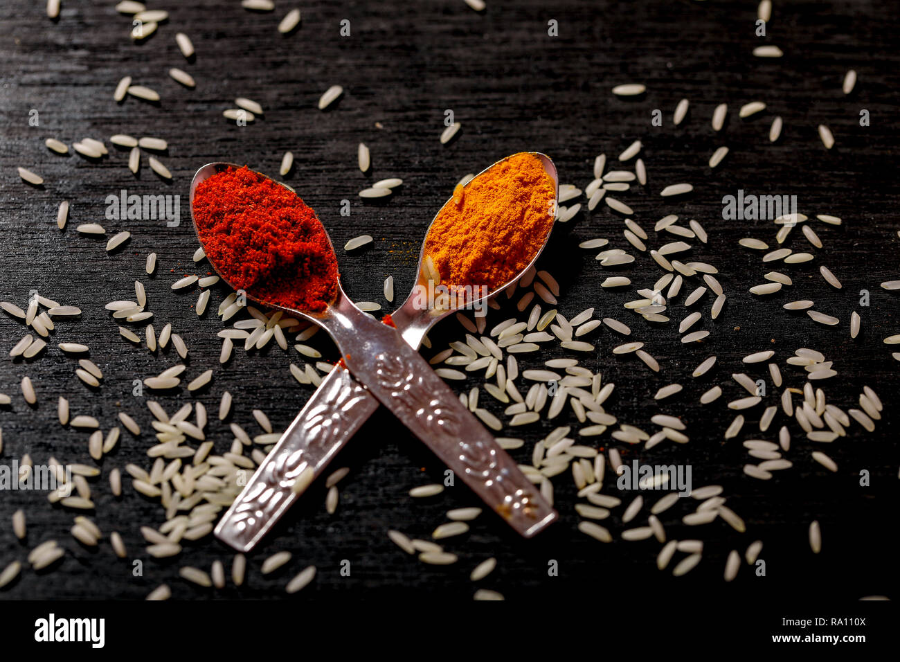 spices in spoons on black background Stock Photo - Alamy