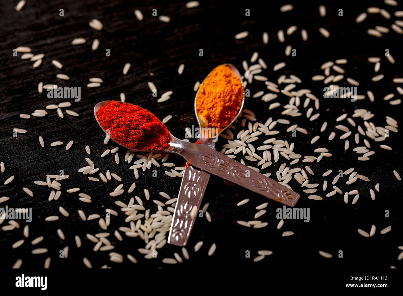 spices in spoons on black background Stock Photo - Alamy