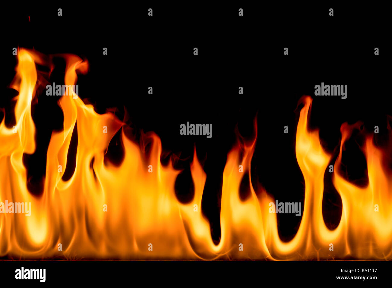 Fire flames on black background. Bright and colorful fire against a black night. Stock Photo