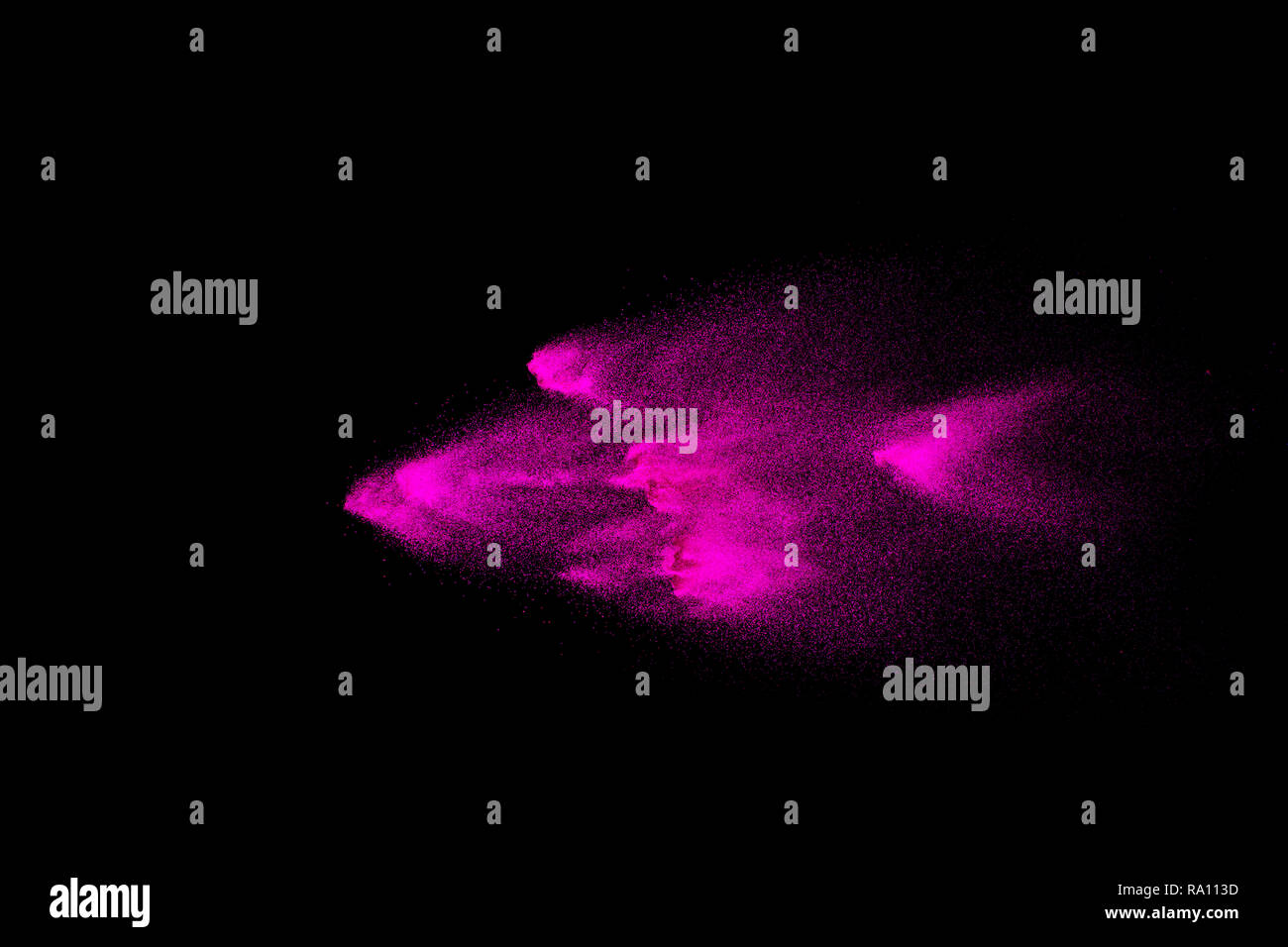 Abstract pink powder explosion on black background. Freeze motion of ...