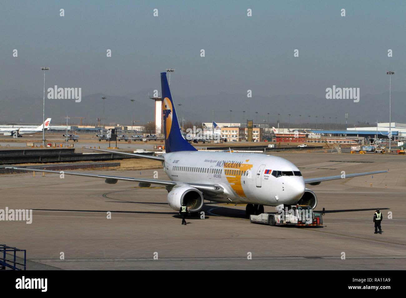 Beoing 737-700 Mongolian Airlines. National flag carrier, Mongolian Ailrlines. Pushing off at Beijing Capital International Airport, China. Stock Photo