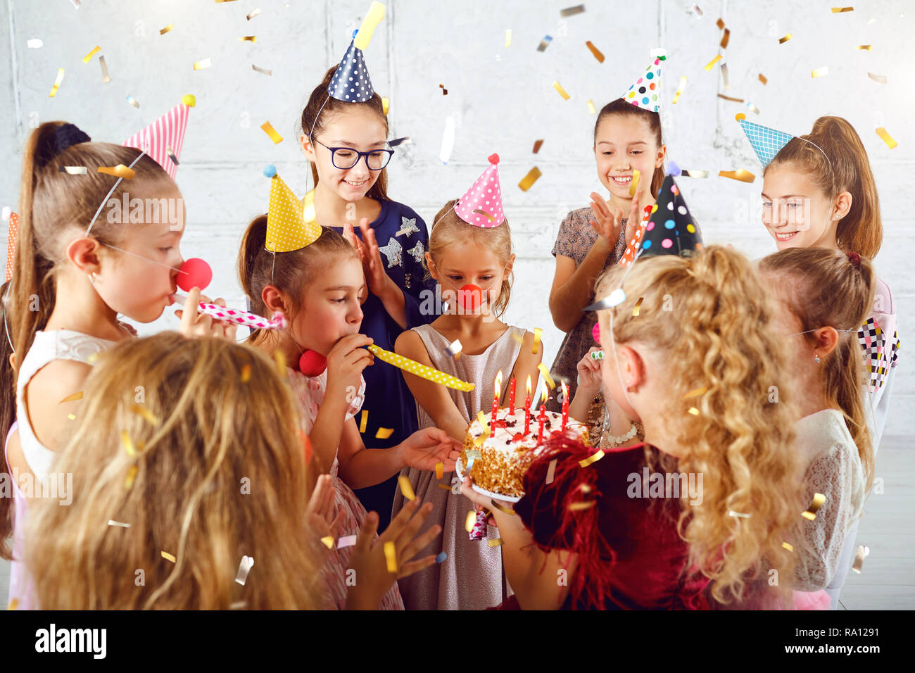 Children with a birthday cake have fun. Stock Photo