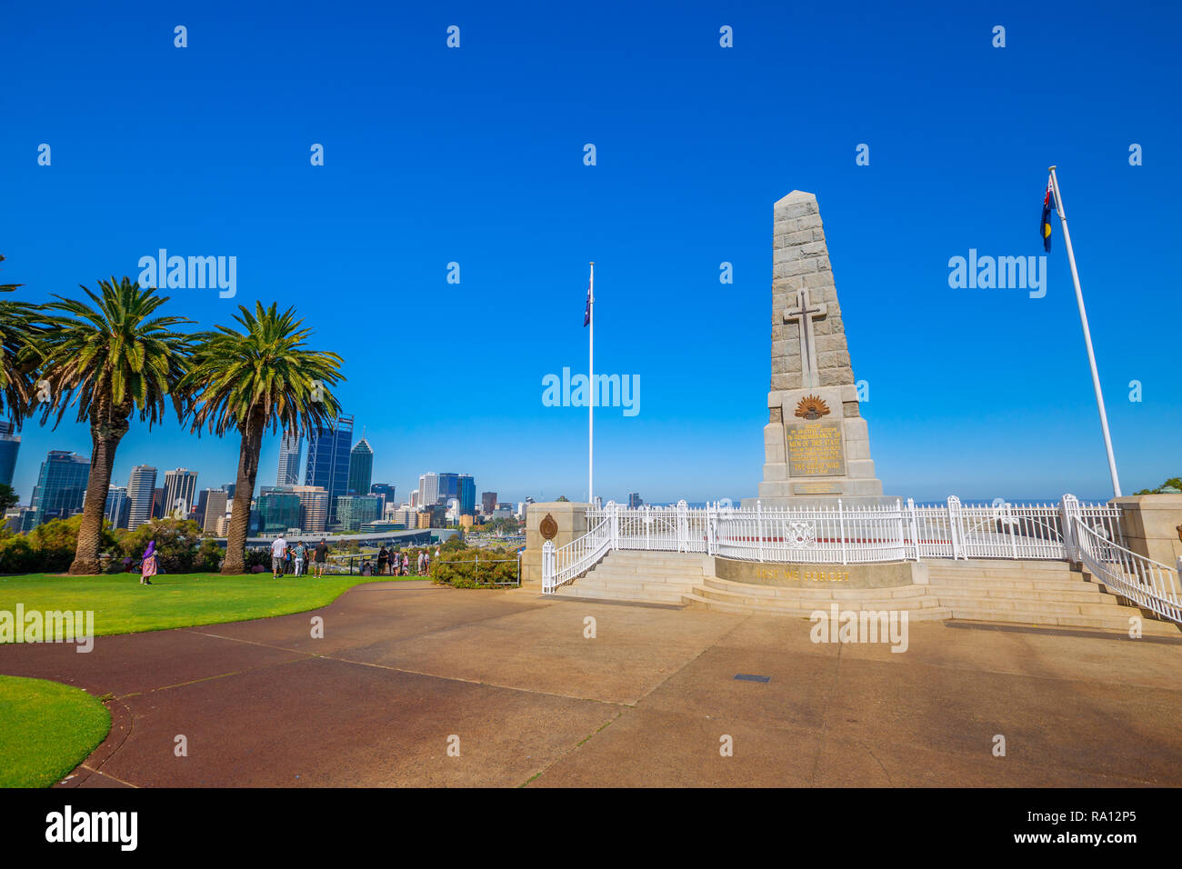 Perth, Australia - Jan 3, 2018: State War Memorial on Mount Eliza in Kings Park. Perth cityscape on background. Kings Park is a large park in Perth by Western Australian Botanic Garden. Blue sky. Stock Photo